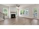 Open living room with a fireplace, hardwood floors, and bright windows at 1577 Periwinkle Dr, Mount Pleasant, SC 29466