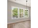 Bright living room featuring a three-panel window and a modern light fixture at 1577 Periwinkle Dr, Mount Pleasant, SC 29466