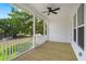 Covered screened porch with wood flooring, ceiling fan, and white railings at 1577 Periwinkle Dr, Mount Pleasant, SC 29466
