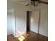 Bedroom with hardwood floors, ceiling fan, closet, and doorway to the next room at 1601 Westmoreland Ave, Charleston, SC 29412