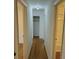 Hallway with wood floors, closet, and doorway to a bathroom with shower at 1601 Westmoreland Ave, Charleston, SC 29412