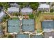 Aerial view of condos showcasing proximity to tennis courts, lush landscaping, and community layout at 1627 Live Oak Park, Seabrook Island, SC 29455