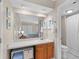 Clean bathroom showcasing a large mirror, vanity with storage, and a shower/tub combo at 1627 Live Oak Park, Seabrook Island, SC 29455