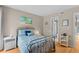 This bedroom is a cozy retreat with wood floors and soft nautical decor at 1627 Live Oak Park, Seabrook Island, SC 29455