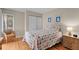 Cozy bedroom with a colorful quilt, wood floors, and a bright window with a relaxing sitting area at 1627 Live Oak Park, Seabrook Island, SC 29455