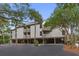 Exterior of a raised condo building with multiple balconies, lush landscaping, and convenient covered parking at 1627 Live Oak Park, Seabrook Island, SC 29455