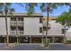 Elevated condo exterior with multiple balconies, covered parking, and lush surroundings, providing a coastal living experience at 1627 Live Oak Park, Seabrook Island, SC 29455