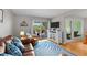 Relaxing living area featuring plush seating, a modern entertainment center, and access to a private outdoor patio at 1627 Live Oak Park, Seabrook Island, SC 29455