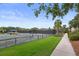 Well-maintained tennis courts alongside a paved path and green grass, offering a picturesque and active community setting at 1627 Live Oak Park, Seabrook Island, SC 29455