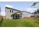 The house features a screened-in porch, and green lawn. with a wood fence at 174 Red Bluff St, Summerville, SC 29483