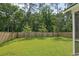 A spacious backyard featuring lush green grass, and a privacy fence at 174 Red Bluff St, Summerville, SC 29483
