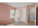 Cozy bedroom with light pink walls, a white dresser, and a window with blinds at 174 Red Bluff St, Summerville, SC 29483