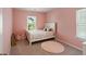 Pink bedroom featuring a white bed frame, light, and a window with natural light at 174 Red Bluff St, Summerville, SC 29483