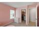 Pink bedroom featuring a white bed frame, closet, and a window with natural light at 174 Red Bluff St, Summerville, SC 29483