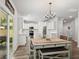 Open-concept dining area with hardwood floors and bright modern kitchen at 174 Red Bluff St, Summerville, SC 29483