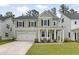 Charming two-story home with a well-manicured lawn and a welcoming front porch at 174 Red Bluff St, Summerville, SC 29483
