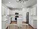 Bright kitchen with white cabinetry, stainless steel appliances, and hardwood floors at 174 Red Bluff St, Summerville, SC 29483