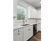 Clean kitchen with stainless steel sink, white cabinets and countertops at 174 Red Bluff St, Summerville, SC 29483