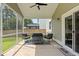 Screened-in patio with comfortable seating area and view of fenced yard at 174 Red Bluff St, Summerville, SC 29483