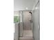 Modern glass shower featuring tiled walls and a rainfall showerhead in a bright and airy bathroom at 174 Red Bluff St, Summerville, SC 29483
