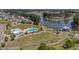 Beautiful aerial view of the community with a central pool, clubhouse, winding walking paths, and a scenic pond at 183 Calm Water Way, Summerville, SC 29486