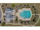 Top-down aerial view of a community pool and clubhouse with plenty of lounge chairs and meticulously landscaped grounds at 183 Calm Water Way, Summerville, SC 29486