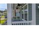 Relaxing covered balcony with ceiling fans and views of the lush front yard at 183 Calm Water Way, Summerville, SC 29486