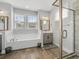 Bright bathroom featuring a soaking tub, glass-enclosed shower, dual sinks, and modern fixtures, creating a spa-like experience at 183 Calm Water Way, Summerville, SC 29486