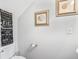 Cozy bathroom featuring a toilet, seashell decor, and framed bathroom rules wall art above the toilet at 183 Calm Water Way, Summerville, SC 29486