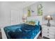Well-lit bedroom featuring a blue bedspread, wood-look fan, and lovely decor at 183 Calm Water Way, Summerville, SC 29486