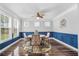 Cozy dining room with dark wood floors, blue wainscoting, and a chandelier, creating a warm and inviting atmosphere at 183 Calm Water Way, Summerville, SC 29486