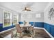 Bright dining room featuring elegant wainscoting, a modern chandelier, and a stylish circular table with comfortable seating at 183 Calm Water Way, Summerville, SC 29486