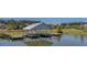 A scenic covered dock with wooden platforms, gracing a tranquil lake, beckons for peaceful moments and relaxation at 183 Calm Water Way, Summerville, SC 29486