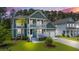 Inviting two-story home with a charming porch, lush lawn, and a well-manicured landscape at 183 Calm Water Way, Summerville, SC 29486