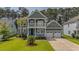 Charming home featuring a lush front lawn and a spacious two-car garage with a double driveway at 183 Calm Water Way, Summerville, SC 29486
