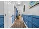 Hallway with blue wainscoting, hardwood floors, and a glimpse into the living room at 183 Calm Water Way, Summerville, SC 29486