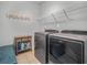 Well-equipped laundry room with modern washer and dryer and storage cabinet at 183 Calm Water Way, Summerville, SC 29486