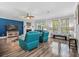 Bright living room featuring teal leather furniture, fireplace, ceiling fan, and wood flooring at 183 Calm Water Way, Summerville, SC 29486