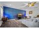 Living room showcases blue accent wall, soft carpet, and views to the outside at 183 Calm Water Way, Summerville, SC 29486
