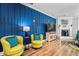Stylish living room featuring a blue accent wall, fireplace, and hardwood floors at 183 Calm Water Way, Summerville, SC 29486