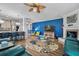 Open-concept living area with a blue accent wall, fireplace, hardwood floors, and an adjacent breakfast bar at 183 Calm Water Way, Summerville, SC 29486
