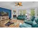 Bright living room featuring teal leather furniture, fireplace, ceiling fan, and wood flooring at 183 Calm Water Way, Summerville, SC 29486