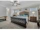 A luxurious main bedroom featuring tufted headboard, neutral walls, soft lighting, and carpeted floors at 183 Calm Water Way, Summerville, SC 29486