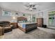 A spacious main bedroom featuring a tufted headboard, ceiling fan, and natural light, creating a comfortable and relaxing space at 183 Calm Water Way, Summerville, SC 29486