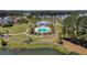 A pristine blue swimming pool with lounge chairs and a pool house, nestled in a lush green landscape near the water at 183 Calm Water Way, Summerville, SC 29486