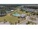 An aerial view of a neighborhood swimming pool complete with blue water, lounge chairs, and a pool house at 183 Calm Water Way, Summerville, SC 29486