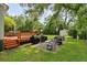 Expansive backyard featuring an outdoor kitchen with a grill and a patio with a seating area at 19 Avondale Ave, Charleston, SC 29407