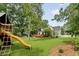 Backyard with a playground, deck, and spacious yard for outdoor activities at 19 Avondale Ave, Charleston, SC 29407