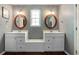 Bathroom includes dual sinks, vanity and bench with natural lighting at 19 Avondale Ave, Charleston, SC 29407
