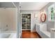 Bathroom showcasing open closet storage, vanity and shower-tub combination at 19 Avondale Ave, Charleston, SC 29407